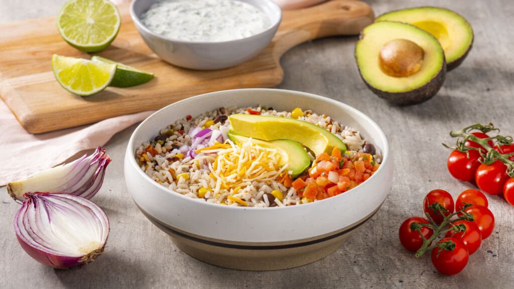 southwest-rice-and-beans-bowl-with-avocado-salsa-shredded-mexican-cheese-blend-red-onion-and-cilantro-lime-cream